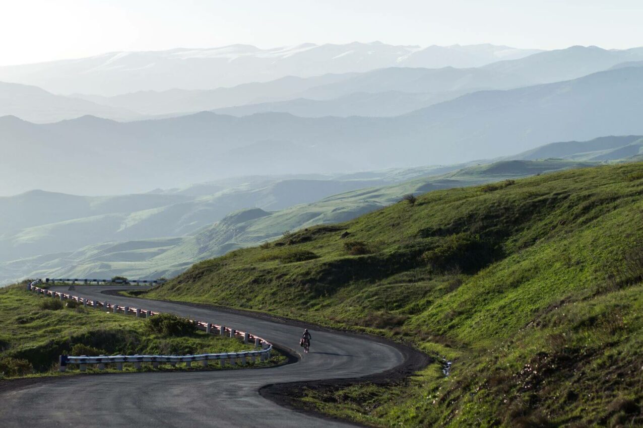 El mito del entrenamiento base y otros errores del ciclismo en invierno empty road and silhouettes of mountains in the mis
