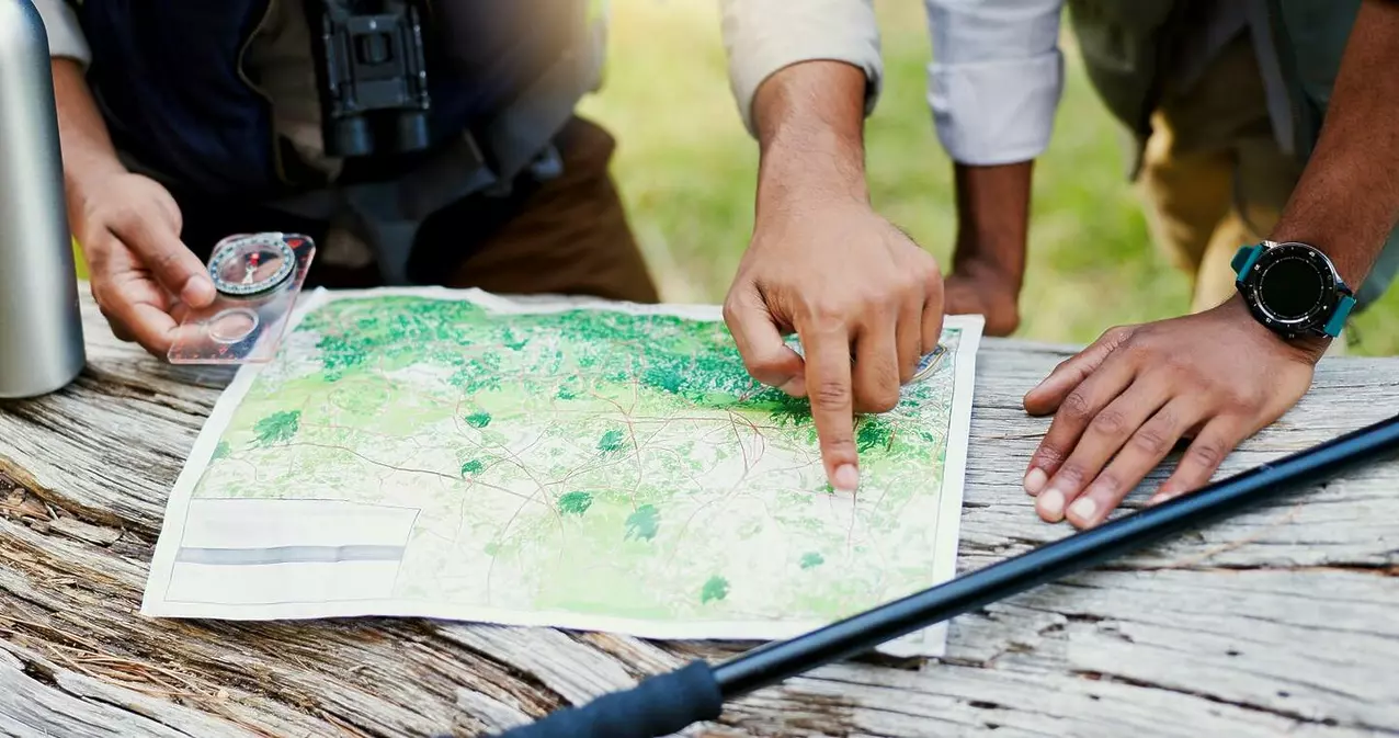 Packing essentials for hiking, trekking and outdoor activities (depending on the route) hands men and maps for hiking outdoor of trekking 2025 04 05 22 10 57 utc